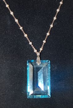 I love the large jewel on this necklace! It is 1 1/2 inches by 7/8 inch and has a sterling bale. The necklace is sterling and has French hallmarks on the catch. The tiny pearls are made of glass and are not real. The chain length is 15 1/2 inches. The total effect is just lovely. In nice condition with some tiny flea bits to the jewel. French and C. 1930. Follow me on instagram @jettesjewels Art Deco Pearl Pendant Jewelry For Gift, Elegant Collectible Necklaces With Rectangular Pendant, Art Deco Pearl Pendant Necklace As Gift, Vintage Blue Necklace With Pearl Pendant, Formal Blue Necklace With Pearl Pendant, Faceted Silver Pearl Necklace For Gift, Formal Blue Pearl Pendant Jewelry, Formal Blue Jewelry With Pearl Pendant, White Hoop Earrings