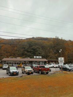 cars are parked in front of a diner