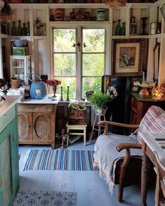 an old fashioned kitchen with lots of clutter