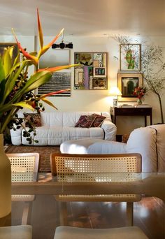 a living room filled with furniture and plants