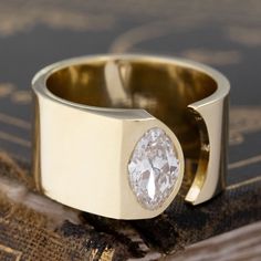 Part of our latest "Melrose" collection of settings - these are cigar band inspired but with an open notch to truly enhance and showcase the silhouette of the diamond. The lines are elegant and clean, with a nod to architectural lines. Bold on the finger, and statement-making. The marquise is a vintage number - charming and bright, and perfect in this setting. 18kt yellow gold Size 7 & resizable. Fits more like 6.5 due to larger width Band weighs 15.3 grams, and measures 10.61mm in width Diamond Contemporary Wedding Ring, Modern Ring Settings, Simple Diamond Engagement Rings, Wide Band Wedding Ring, Modern Ring Design, Wide Band Diamond Rings, Modern Mens Rings, Art Jewelry Earrings, Marquise Cut Diamond