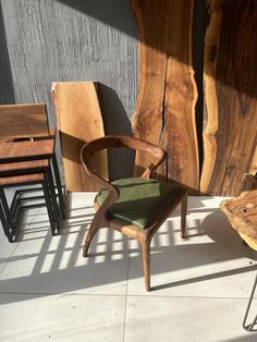 chairs and tables made from wood sit on the floor next to each other in front of a wooden wall