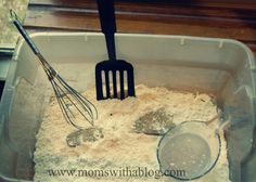 a pan filled with flour and whisks next to a spatula on top of a counter