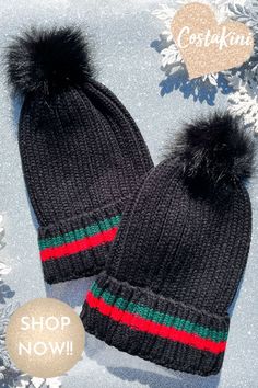 two black knit hats with red, green and blue stripes on the bottom one has a pom - pom