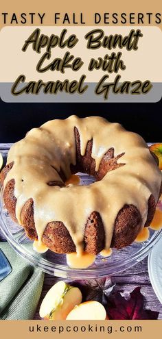 an apple bundt cake with caramel glaze is on a glass platter