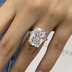 a woman's hand with a diamond ring on it