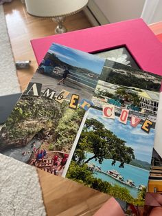 a person holding up some pictures on a table