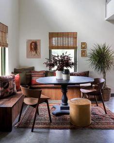 a living room filled with furniture and a potted plant on top of a table