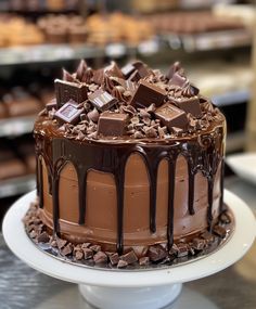 a chocolate cake on a white plate in a bakery