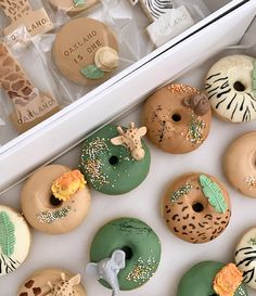 an assortment of decorated doughnuts in a box