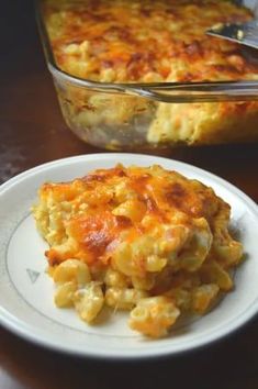 a casserole dish on a plate with a serving spoon next to the casserole