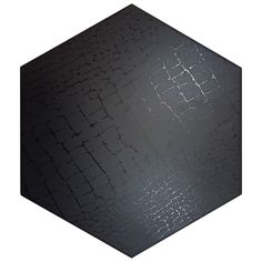 a black hexagonal object with cracks in it