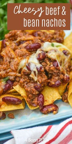 cheesy beef and beans nachos on a plate with tortilla chips