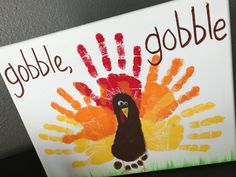 a handprint turkey with the words gobble, gobble written on it in red and orange