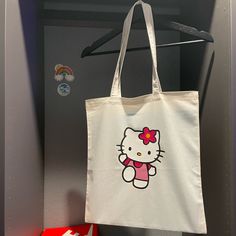 Very Adorable & Great For Carrying Everything Your Items. This Durable Canvas Tote Is Complete With An Open Design, Fixed Shoulder Straps, And Iconic Hello Kitty Graphic Logo. Cheap Hello Kitty Shoulder Bag For Shopping, Cheap Black Hello Kitty Print Bags, Cheap Rectangular Bags With Hello Kitty Print, Hello Kitty Tote Bag, Y2k Tote Bag, Diy Tote Bag Design, Hello Kitty Tote, Tote Bag Business, Handpainted Tote Bags