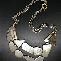 Irregular Pyrite Stone Necklace Fitted On Brass Palm Chain With Toggle Clasp Materials: - Flat Pyrite - Brass Palm Chain - Gold Plated / Brass Accents - Brass Toggle Clasp Measurements: Necklace: Entire Ln - 25in. Color: Silver, Gold, Brass Pyrite Jewelry, Pyrite Stone, Pyrite Necklace, Brass Accents, Gold Brass, Toggle Clasp, Stone Necklace, Womens Jewelry Necklace, Silver Gold