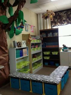 a room filled with lots of books and toy bins next to a book shelf