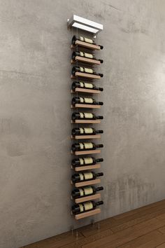 a wine rack with several bottles of wine in it on a wooden floor next to a wall