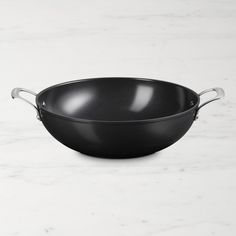 a black frying pan sitting on top of a white counter