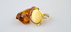 Welcome to my gemstone shop. I guarantee that all my items are handmade by me and made of genuine natural real Baltic Amber gemstone. Medium-size gold-plated silver 925 rings. Handmade from real white Baltic amber. Rings of adjustable size. This item is made of natural - unpressed amber.  Weight:~ 6.77 gr.  The ring can be enlarged from US 6 to US 9 1/2 (ask and we will adjust the ring size).  Ring size:~ 2.34 x 1.96 x 0.84 cm. (0.92x0.77x0.33 inch.).  Stone size:~ 1.80 x 1.30 x 0.70 cm. (0.71x0.51x0.28 inch.).  Free shipping!  Baltic Amber is a natural gemstone. Amber is surprisingly light: it will float in a saturated salt solution--but not in ordinary seawater.  This makes it suitable for large beads or pendants that are still comfortable to wear despite their size.  Amber comes in more Polished 14k Gold Amber Jewelry, 14k Gold Amber Jewelry With Polished Finish, Handmade Baltic Amber Ring, Handmade Baltic Amber Jewelry, Baltic Amber Ring Jewelry Gift, Gold Baltic Amber Jewelry For Anniversary, Baltic Amber Ring For Anniversary, Unique Baltic Amber Gold Jewelry, Gold Baltic Amber Jewelry With Polished Finish