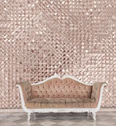 a couch sitting on top of a tiled floor in front of a wall covered with metallic foil