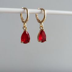 Ruby Red & Crystal Teardrop Teardrop Jewel Huggie Hoop Earrings, 14k Gold Plated Earrings, Vintage Style Earrings, Victorian Earrings  Product specifications: * Material: 14K Gold Plated Brass * Size Each charm measures 1 cm x 0.7cm Earring Options: * 8mm inner diameter hoops * 10mm inner diameter hoops Packaging and Gifts: * All pieces of jewellery are set on a card in a mesh jewellery pouch  Shipping: * All Australian orders will be shipped out within 1 - 3 days by standard untracked letter post. If you require tracking, please upgrade to that option at the time of checkout. I cannot be held responsible for missing orders if you do not upgrade. Delivery within 5 - 6 days. INTERNATIONAL BUYERS please note shipping can sometimes take up to 3 weeks. Care instructions: * Cleaning your jewell Red Hypoallergenic Dangle Hoop Earrings, Red Huggie Earrings For Anniversary, Red Teardrop Hoop Earrings, Red Teardrop Hoop Earrings For Pierced Ears, Red Teardrop Hoop Earrings With Ear Wire, Victorian Earrings, Vintage Style Earrings, Red Crystals, Huggie Hoop Earrings