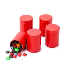 three red containers filled with different colored candies