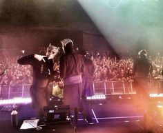 two people standing on stage in front of a crowd