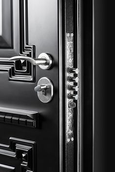 an open door with metal handles and knobs on the front, in black and white