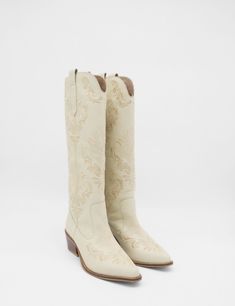 Meet Jolene, the cowboy boot that has the perfect amount of elegance combined with the rugged spirit of the west. Crafted with beautiful intricate stitching, these boots tell a story of adventure and sophistication. They are perfect for the modern cowboy who knows strength and style. ETHICALLY HANDMADE IN COLOMBIA BY STIVALI NEW YORK MATERIALS Upper smooth leather FEATURES Western booties Semi-Pointed toe Stacked leather-wrapped heel Generational artisanal stitching MEASUREMENTS Heel Height: 2.5 Modern Cowboy, The Cowboy, Western Booties, Tell A Story, White Boots, Cowboy Boot, Greek Life, Leather Shoes Woman, Western Cowboy Boots