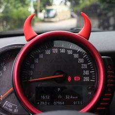 the speedometer is red and has horns on it