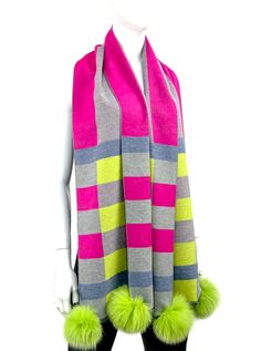 100% viscose scarf Checkered and stripe detail with grey, hot pink, and lime green Green fox fur poms Shop the scarf with all pink accents here Sorel Sandals, Denim Jacket With Fur, Woven Scarf, Drawing Bag, All Pink, Woven Scarves, Ooh La La, Spirit Wear, Genuine Leather Handbag