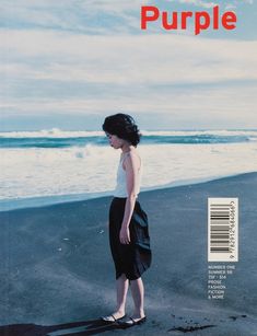 a magazine with a woman standing on the beach