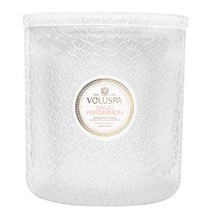 the vouspa super candle is white and has gold trimmings on it