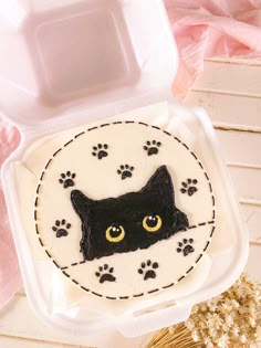 a cake with a black cat's face on it