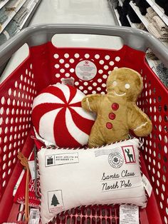 a red shopping basket filled with stuffed animals and candy canes on top of it