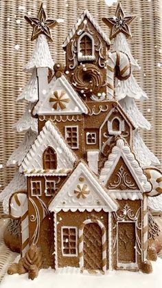 a small gingerbread house is decorated with icing