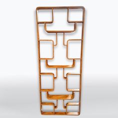 a wooden sculpture with squares and rectangles on it's sides, against a white background