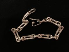 Beautiful vintage sterling silver chain link bracelet with a snap-lock closure. The bracelet has a beautiful design. It measures 8.25 inches in length. There are a few minor superficial scratches. Formal Chain Link Bracelet With Hook And Links, Sterling Silver Link Paperclip Bracelet For Formal Occasions, Sterling Silver Link Paperclip Bracelet For Formal Events, Formal Sterling Silver Link Bracelet With Chain Detail, Formal Chain Link Bracelet With Box Clasp, Formal Sterling Silver Link Bracelet, Sterling Silver Bracelet With Oval Links, Silver Paperclip Bracelet With Oval Links For Formal Occasions, Silver Paperclip Bracelet With Rectangular Links For Formal Occasions