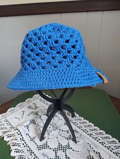 A granny stitch sun hat made from 100% cotton. Machine washable (gentle cycle, cold water); hang or lay flat to dry. Blue Cotton Sun Hat One Size Fits Most, Blue Cotton Sun Hat For Outdoor Use, Blue Crochet Bucket Hat For Spring, Blue Cotton Sun Hat For Outdoor, Cotton Brimmed Sun Hat For Warm Weather, Lightweight Crochet Hat With Curved Brim For Outdoor, Lightweight Brimmed Crochet Hat For Outdoor, Lightweight Curved Brim Crochet Hat For Outdoor, Blue Brimmed Cloche Hat For The Beach