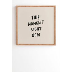 this moment right now is written in black ink on a white paper mounted on a wall