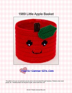 a red knitted basket with a green leaf on it's head and the words, 1989 little apple basket