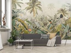 a living room with a couch and wall mural