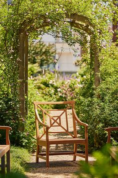 a wooden bench sitting in the middle of a garden