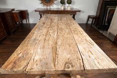 an old wooden table is in the middle of a room