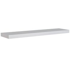 a white shelf sitting on top of a wall