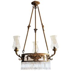 an antique chandelier with glass shades