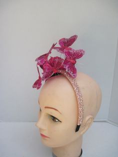 "* This simple yet elegant and sophisticated rich pink butterfly headpiece is the perfect size for any special event. It has been made to complement rather than 'steal the show' and will give you years of wear and hopefully many complements. * Each butterfly has a diameter of 3\" and are shaded in different shades of deep pink. Each is on it's own wire so each can be adjusted as needed. * On an acylic headband with hand sewn acrylic crystals it is well balanced and comfortable to wear for extend Formal Hair Accessories With Matching Adjustable Headband, Formal Hair Accessories With Matching Headband, Pink Headband For Kentucky Derby, Pink Hair Accessories For Spring Formal Events, Elegant Fitted Pink Headband, Formal Pink Hair Accessories, Adjustable Pink Headband For Wedding, Fitted Pink Headband, Pink Hair Accessories For Summer Evening