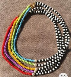 multicolored beaded necklaces are stacked on top of each other