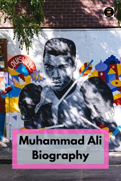 a large mural on the side of a building with words written in spanish and an image of a man holding two boxing gloves